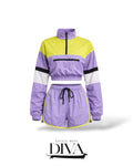 Purple and yellow colorblock two-piece set featuring cropped zip-up windbreaker and matching drawstring shorts