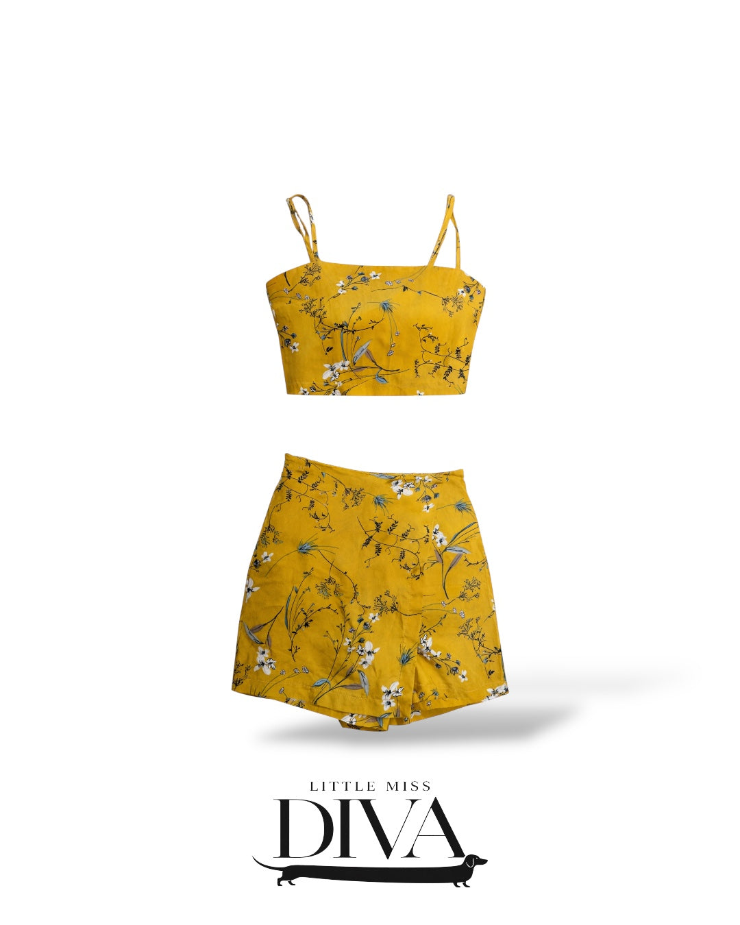 Mustard yellow floral two-piece set featuring a cropped cami top and high-waisted mini skirt with delicate botanical print.