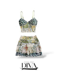 Mixed print two-piece set featuring leopard print bustier top and paisley mini skirt with layered hem