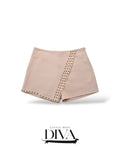 Beige studded skort featuring wrap-style front and gold-tone stud detailing along seams