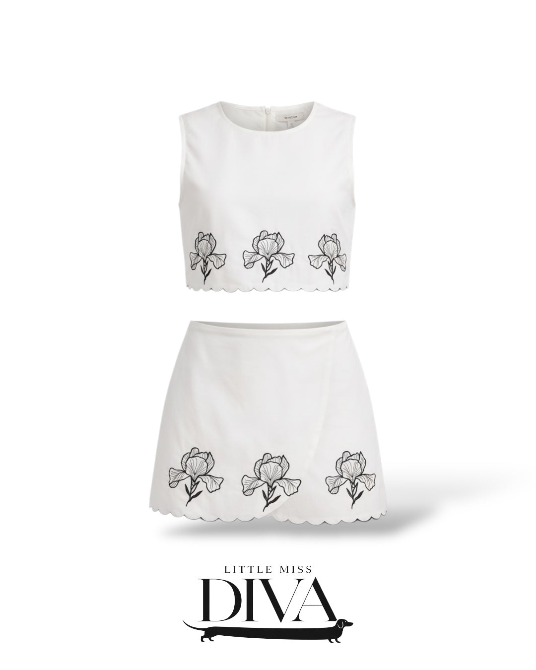 White two-piece set featuring embroidered floral crop top and matching mini skirt with scalloped hem