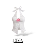 White textured halter top with front tie and pink floral accent