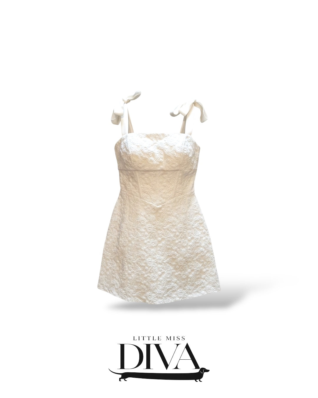 White textured mini dress with adjustable bow tie shoulder straps and fitted silhouette